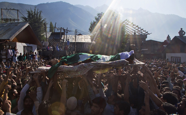 Kashmiri Muslims shout freedom slogans as they carry the body of Nasir Shafi during his funeral procession on the outskirts of Srinagar, Indian controlled Kashmir, on Saturday (AP photo)